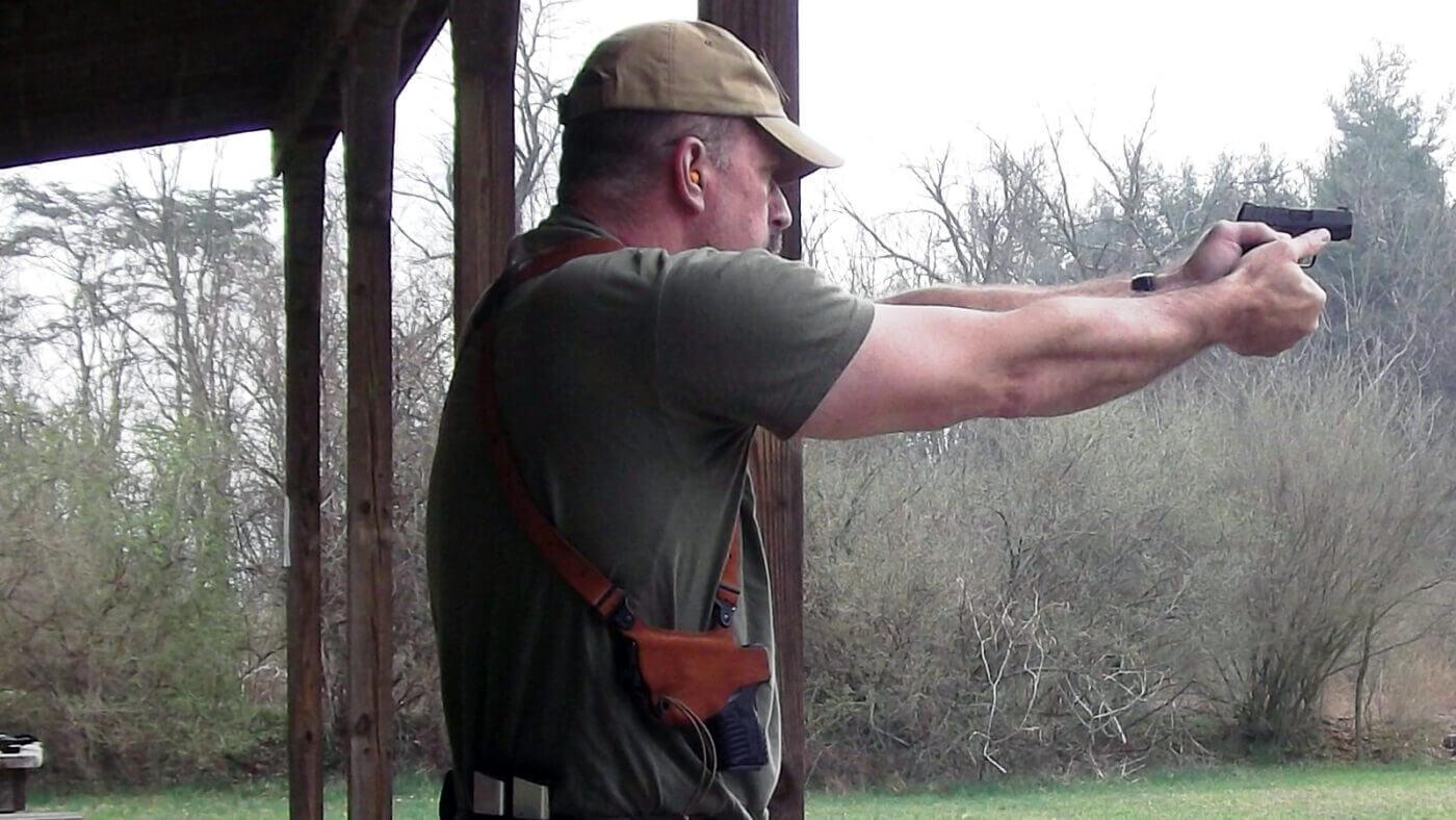 Man shooting a single action .380 pistol