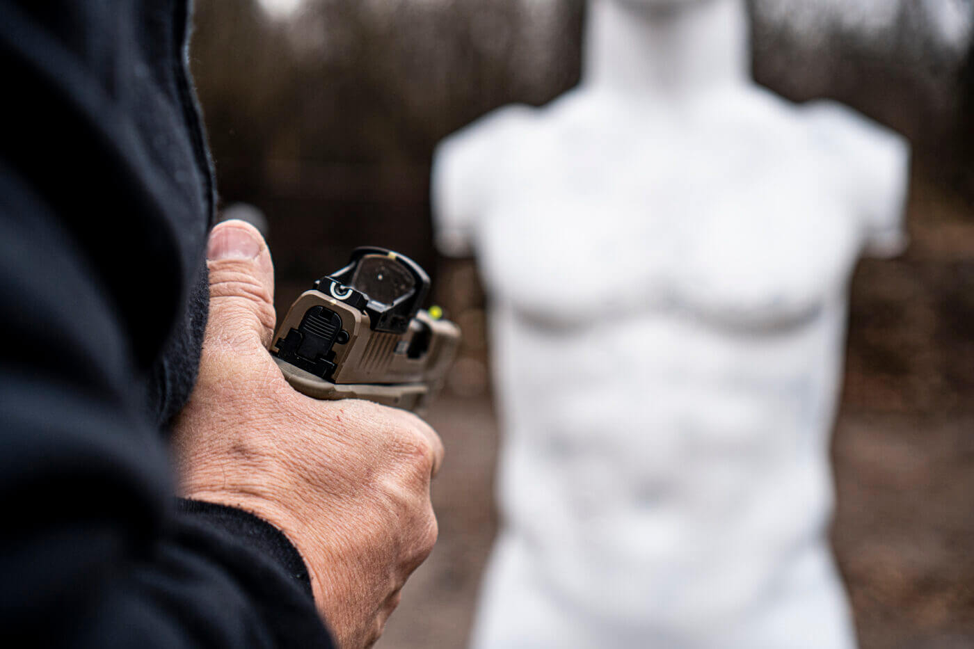 Man shooting at a 3D target from the retention position