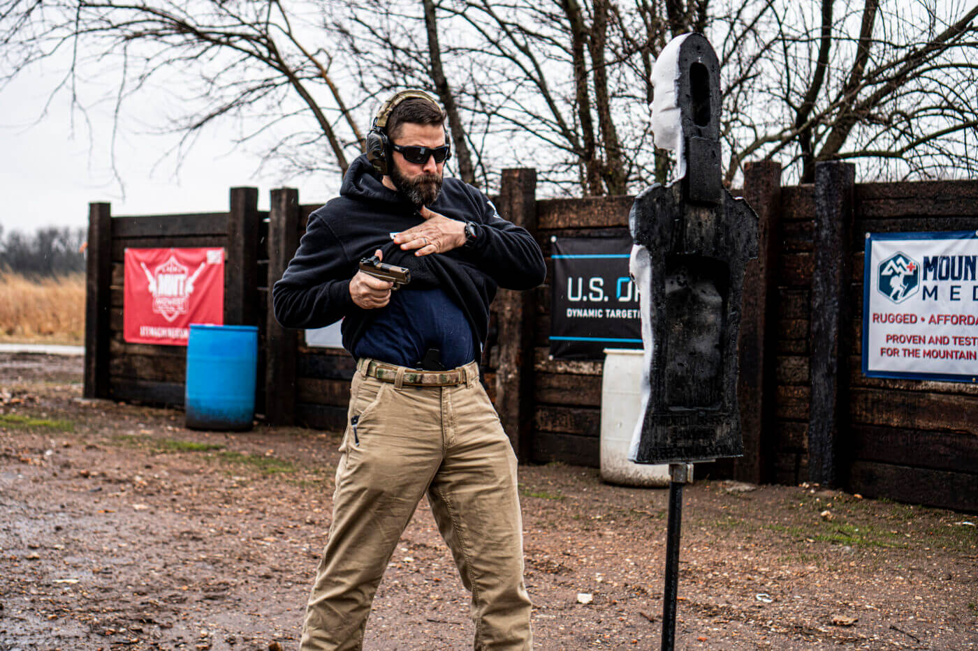 Man demonstrating how to shoot an attacker in close quarters