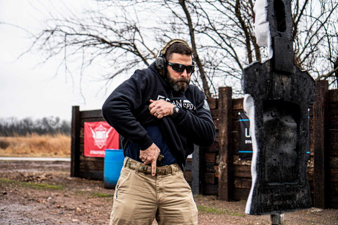 Man demonstrating how to shoot an attacker in close quarters