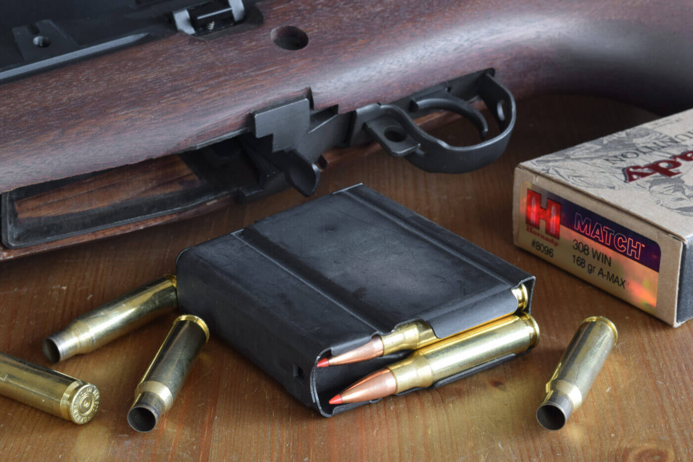 .308 ammo in a rifle magazine with rifle in background