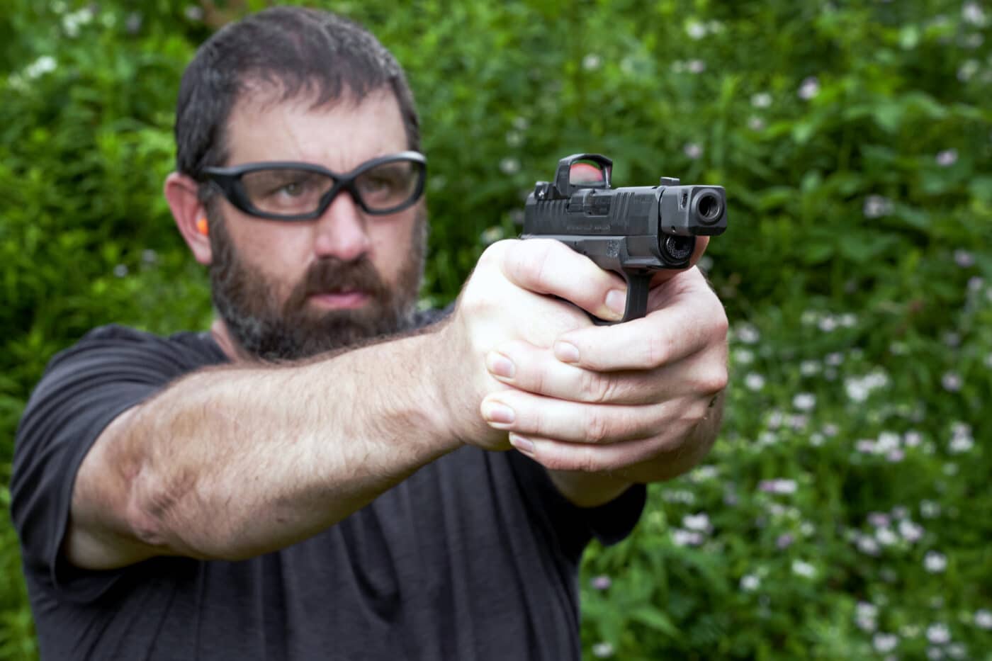 Man shooting a Hellcat RDP pistol with HEX Wasp optic mounted on it