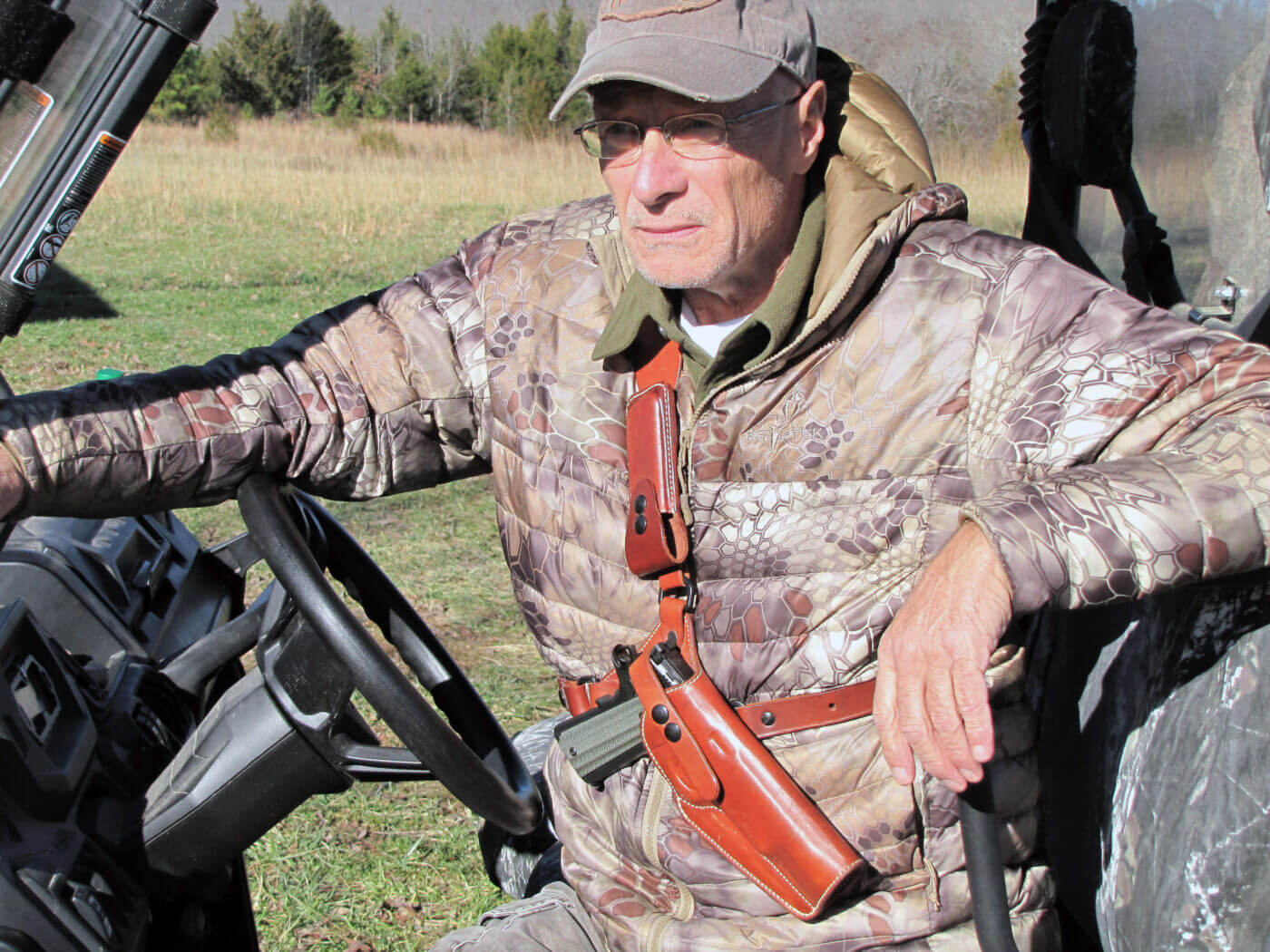 Man wearing a pistol chest rig when driving