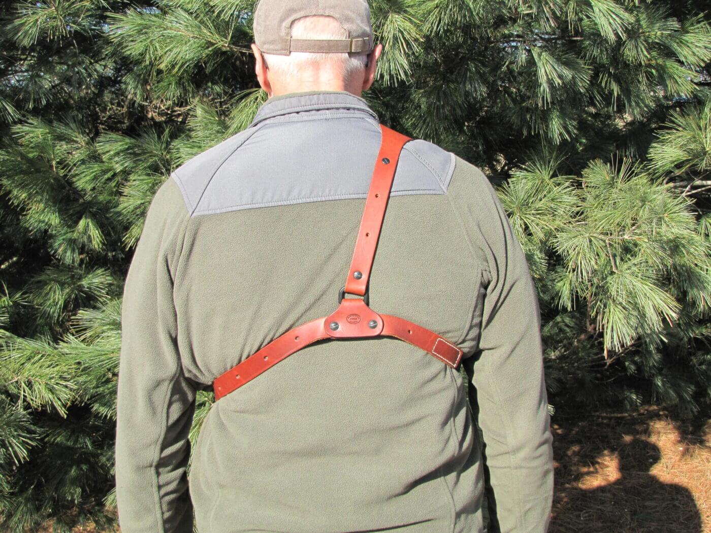 Man testing the carry straps on a chest holster