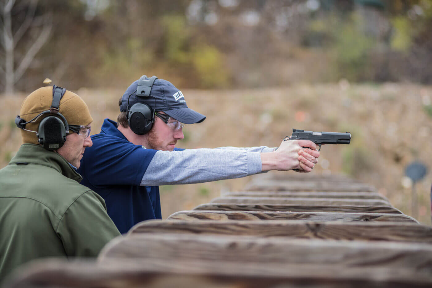 Man teaching a student shooter on the Hillsdale College range