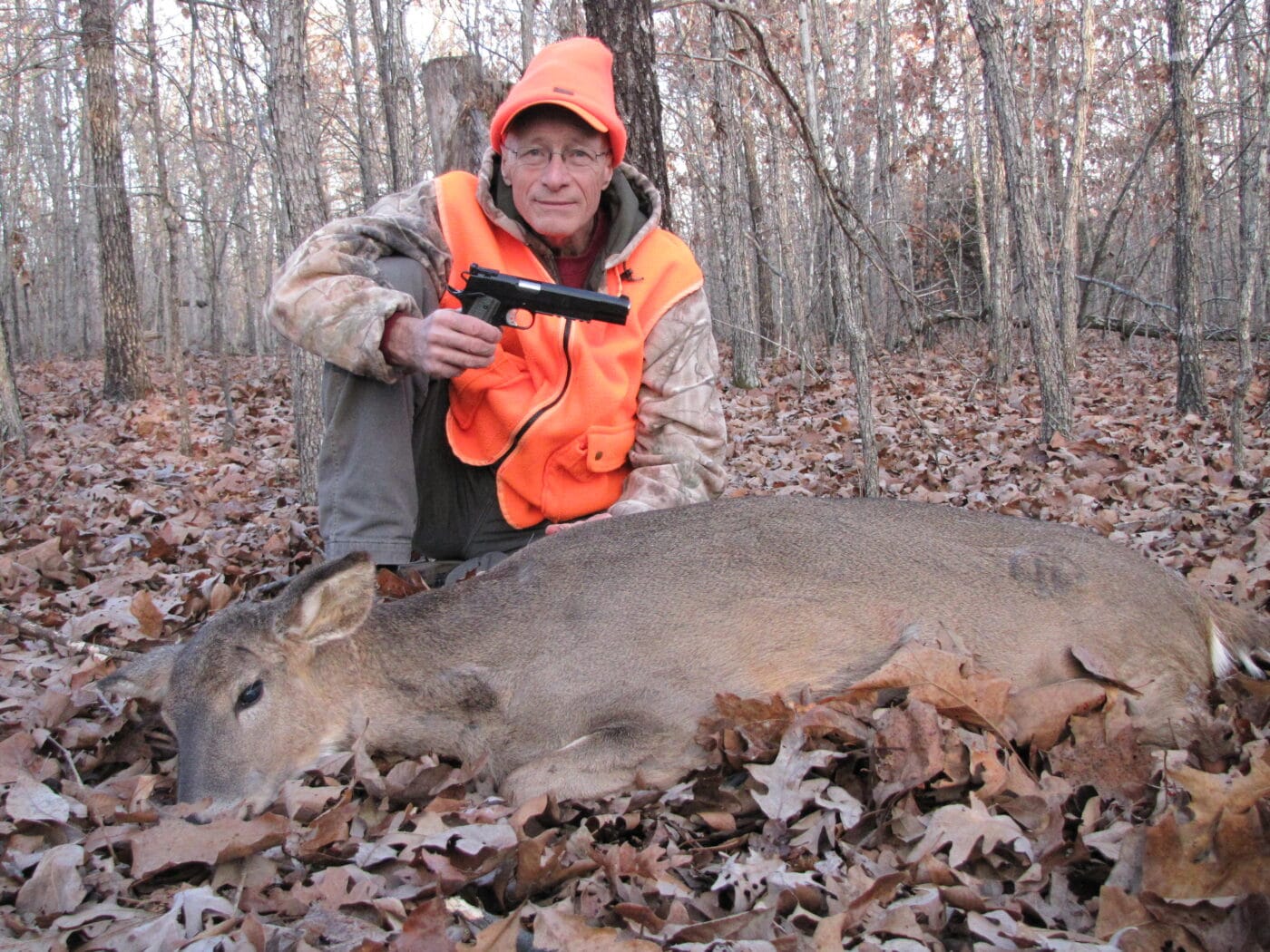 Man posing with a deer shot with a 10mm Hornady Handgun Hunter load and 1911 pistol