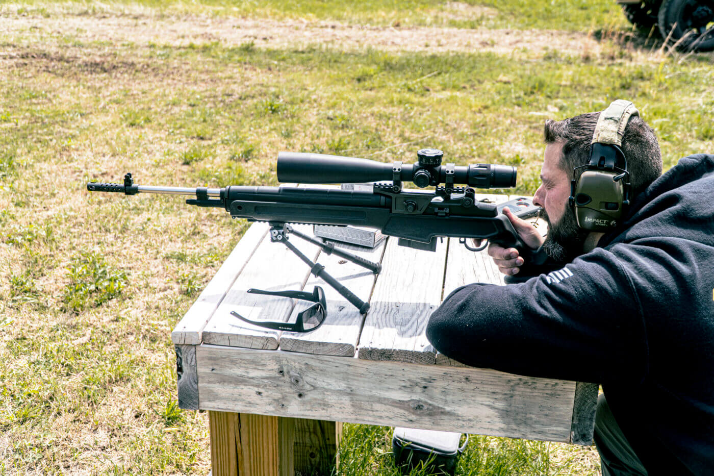 Man shooting the M1A Loaded Precision from a bench for groups