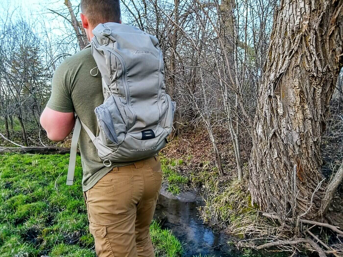 Man carrying the ALPS Ghost 30 backpack