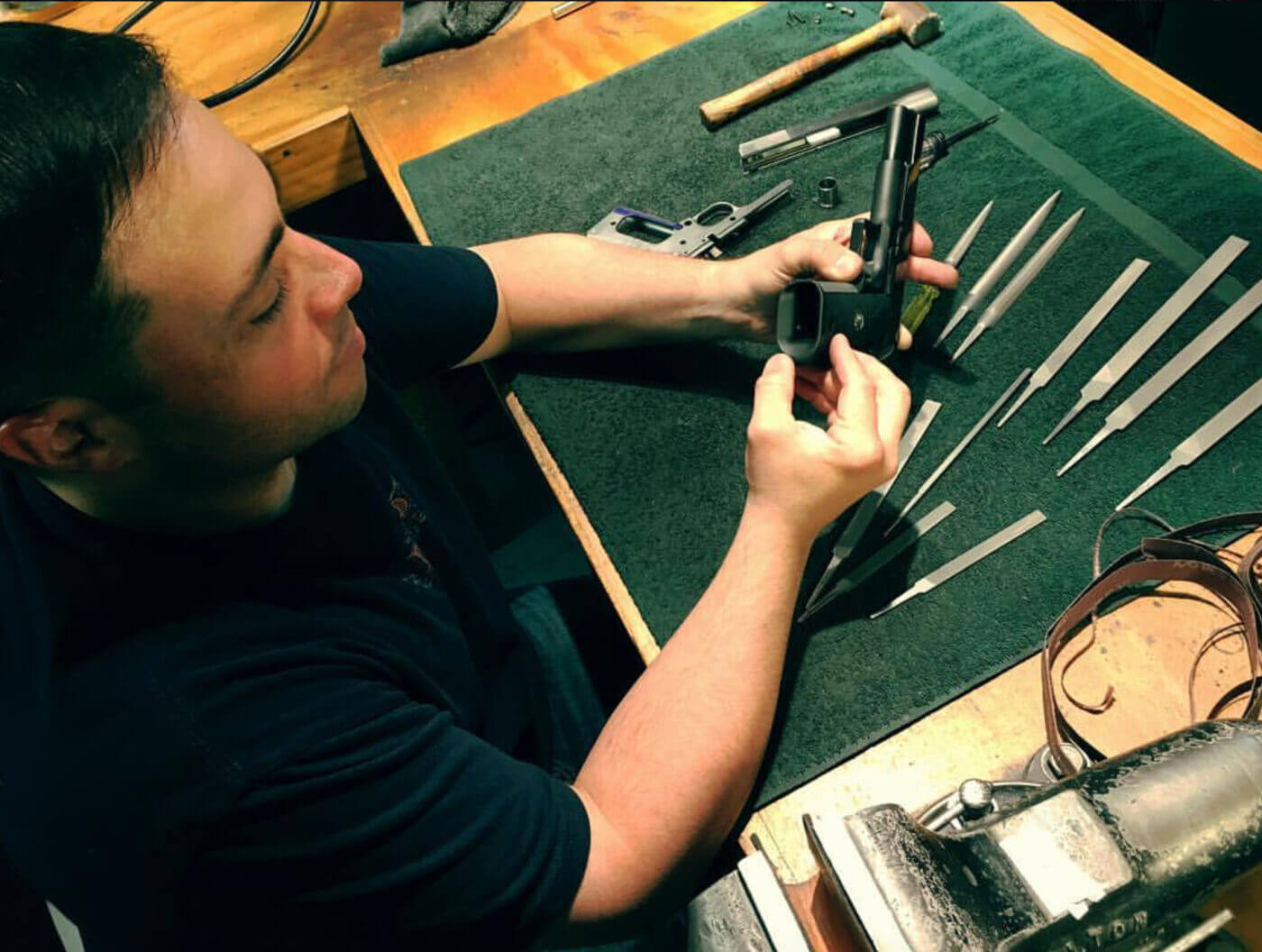 Jason Burton inspecting a custom pistol