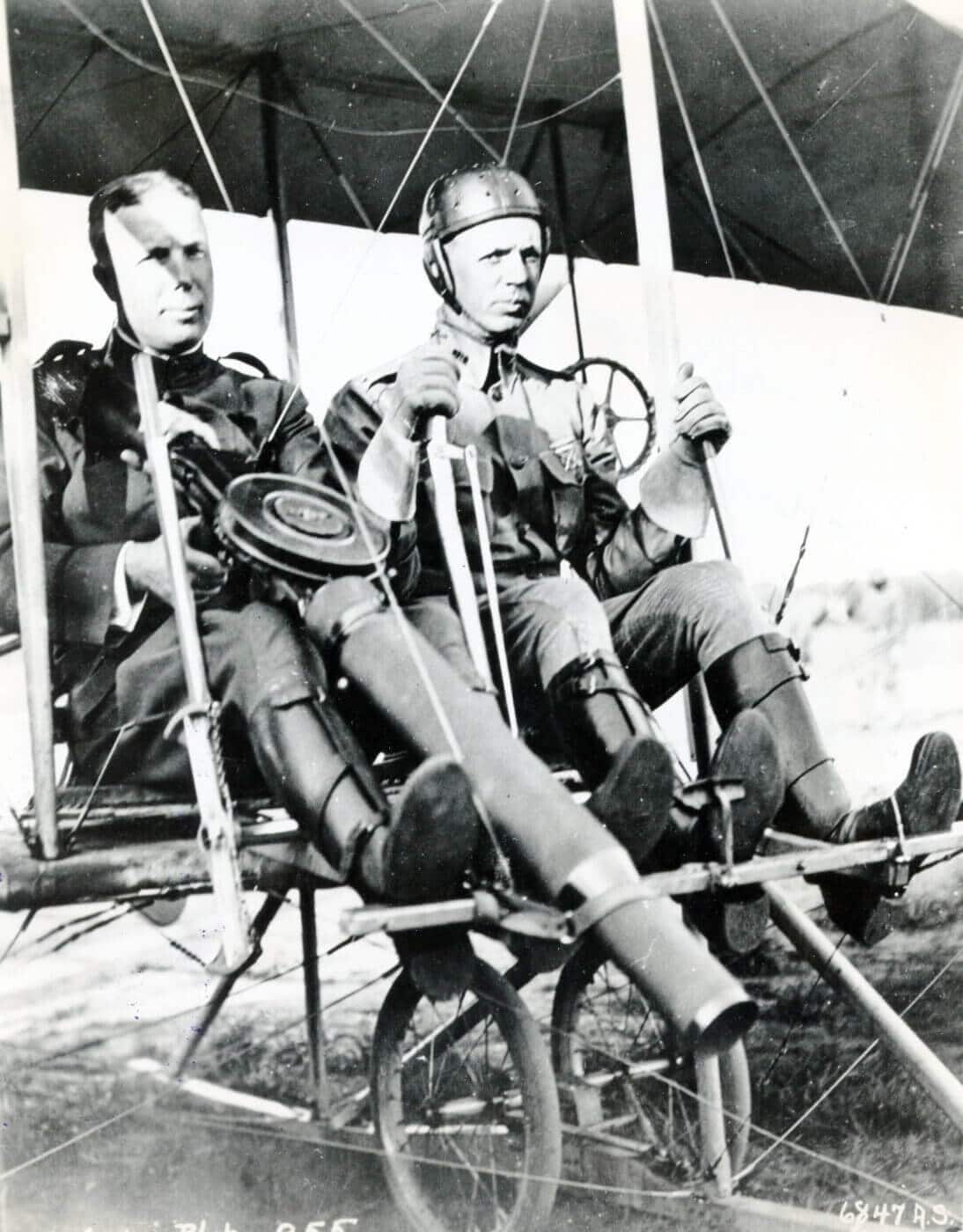 Lewis gun strapped onto a Wright Model B Flyer with two men in plane