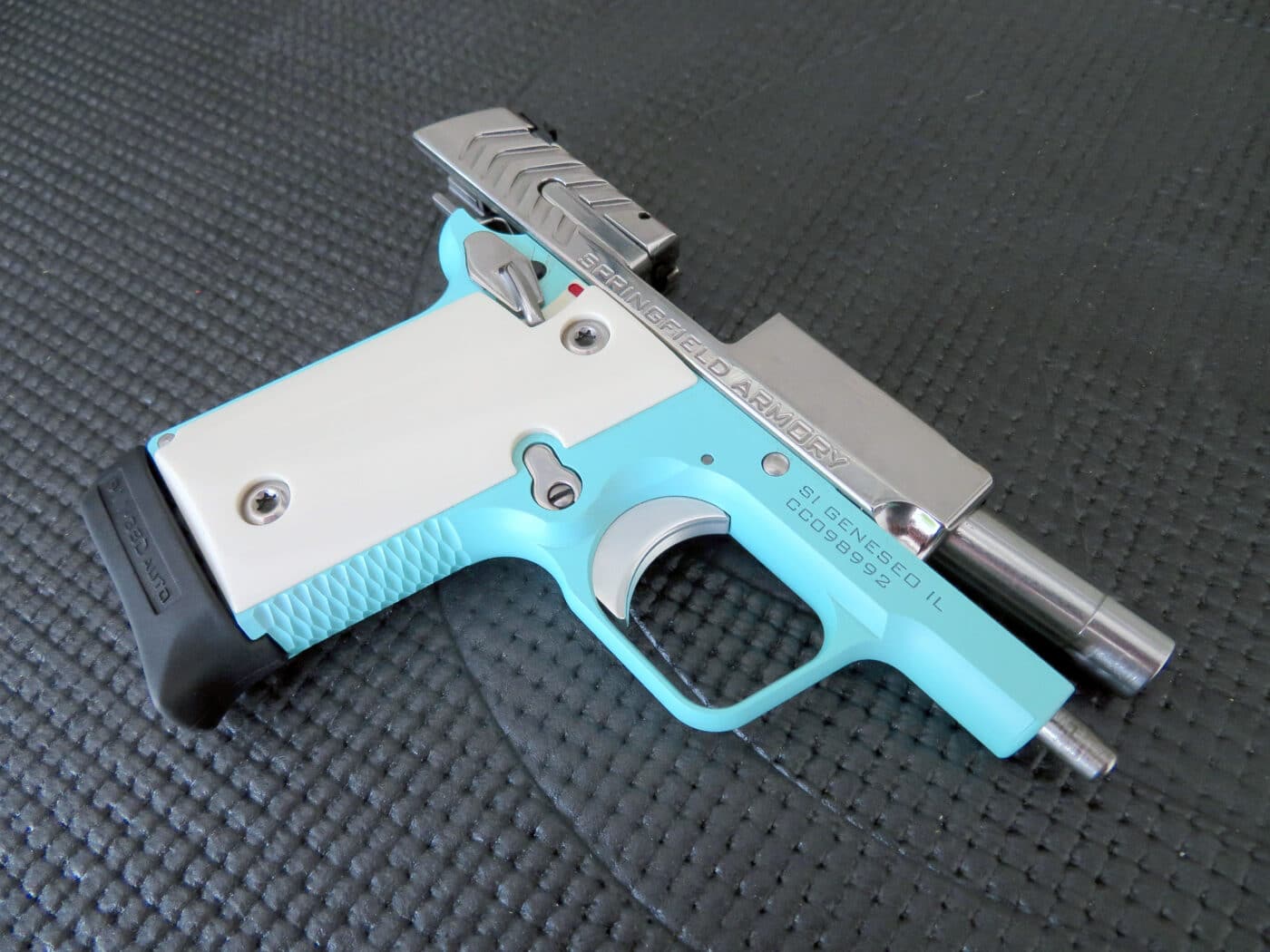 Right side view of the robin egg blue 911 pistol with slide locked back