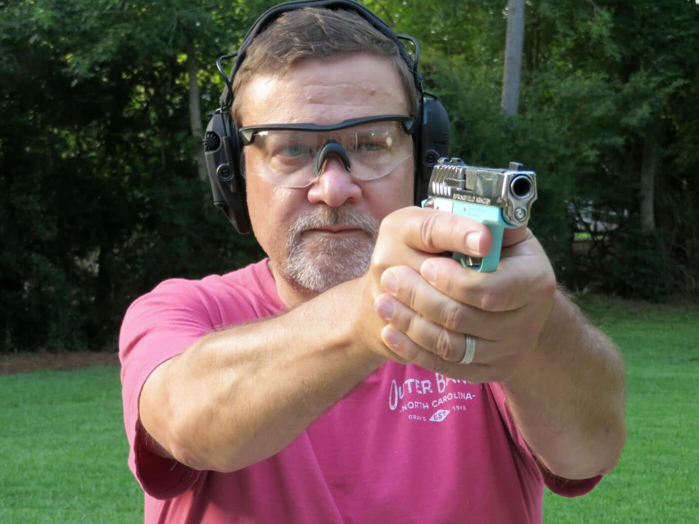 Man shooting a Vintage Blue 911 pistol