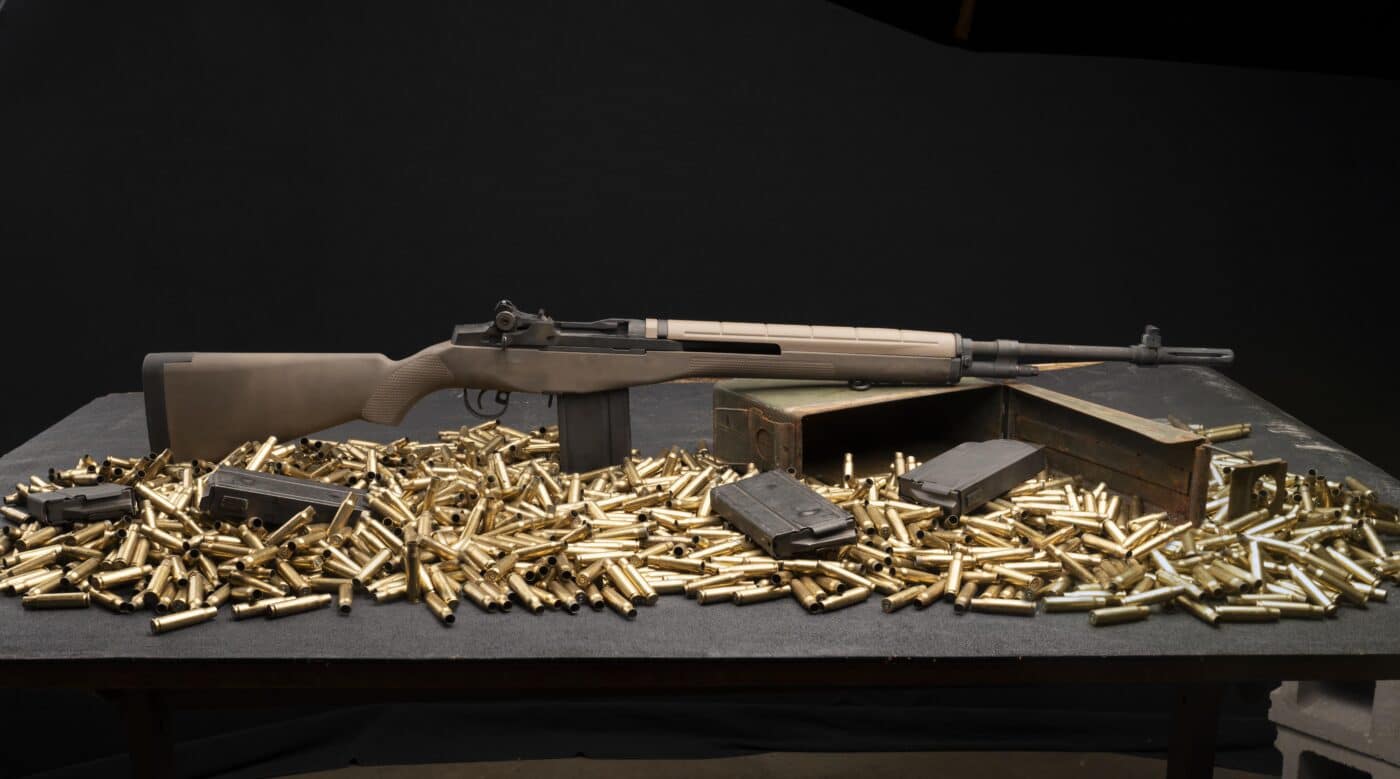 M1A rifle surrounded by ammo on a table