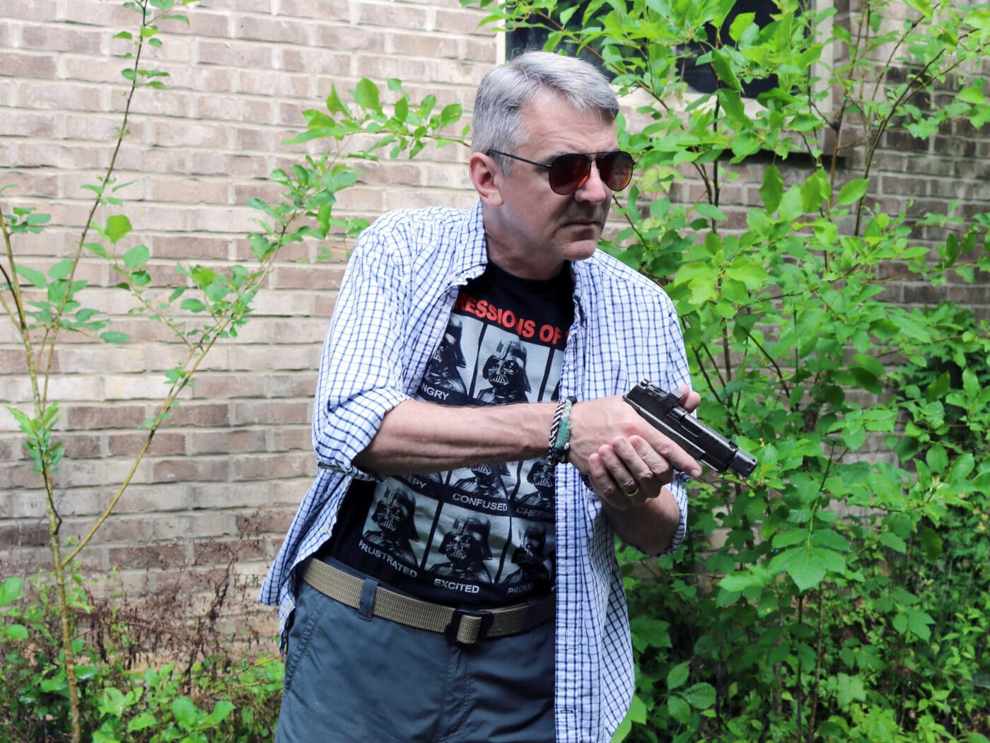 Man holding Springfield Armory Hellcat RDP pistol and using DeSantis holster