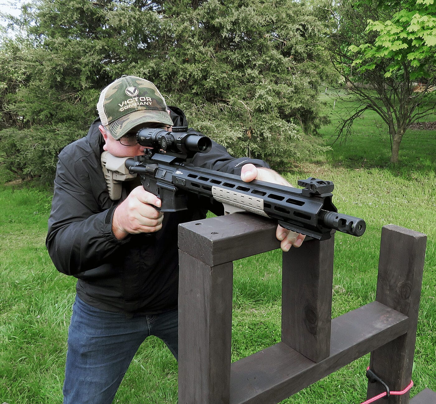 Man using Springfield Armory Victor rifle at a barricade