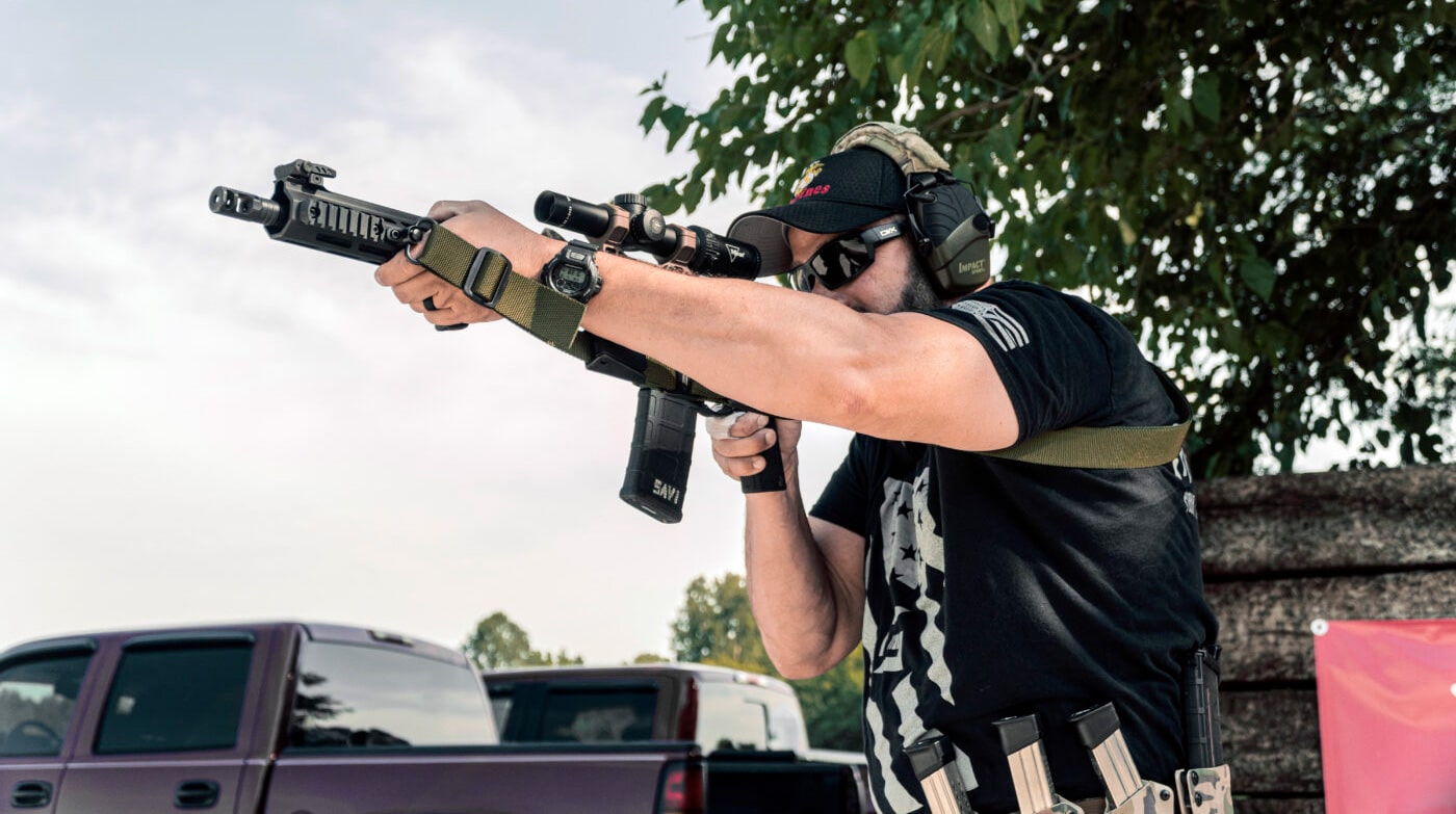 Man using rifle with three-point sling