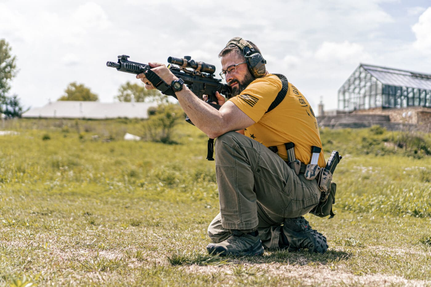 Man shooting SAINT rifle with Trijicon rifle scope
