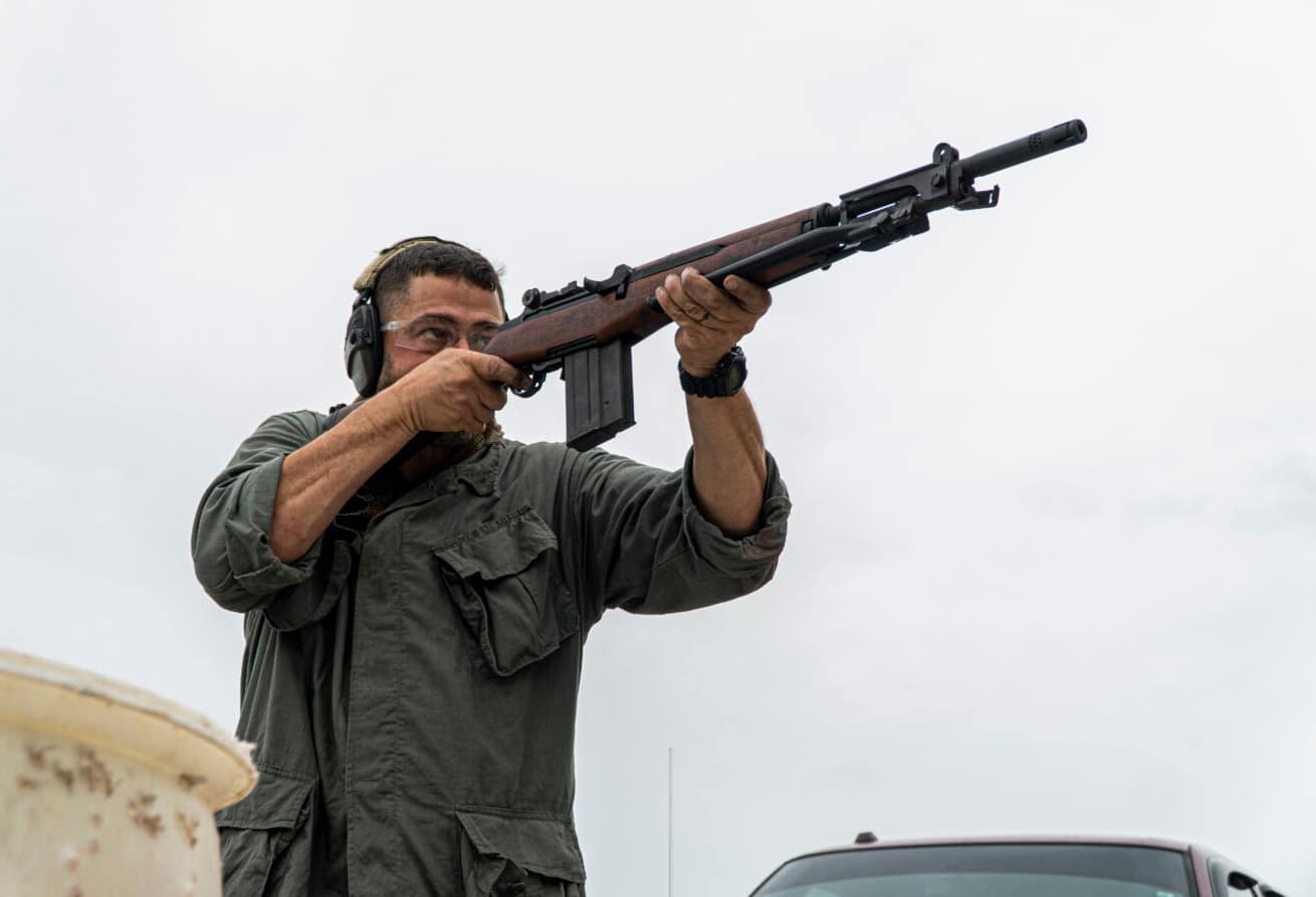 Man shooting a BM 59, an Italian version of a modernized M1 Garand