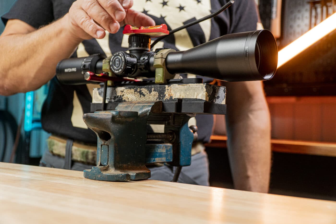 Man starting the scope mounting process using a level