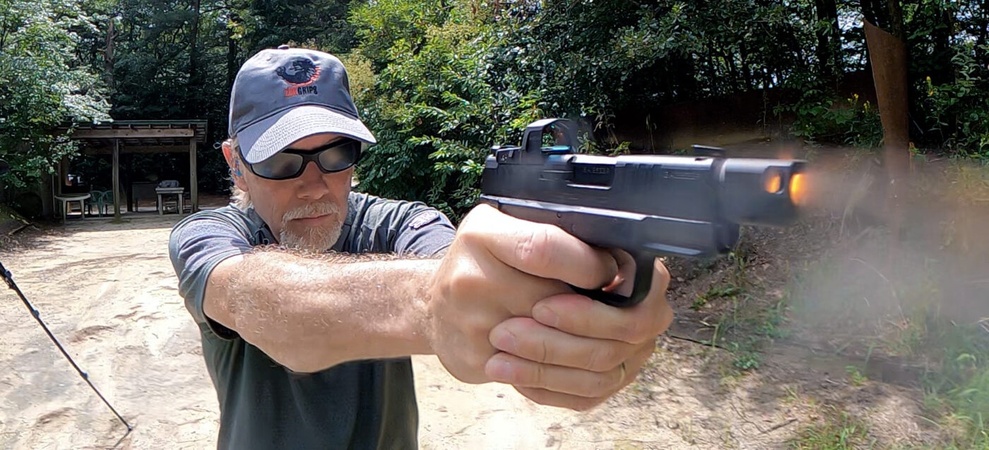 Man tests recoil reduction from Hellcat pistol with compensator