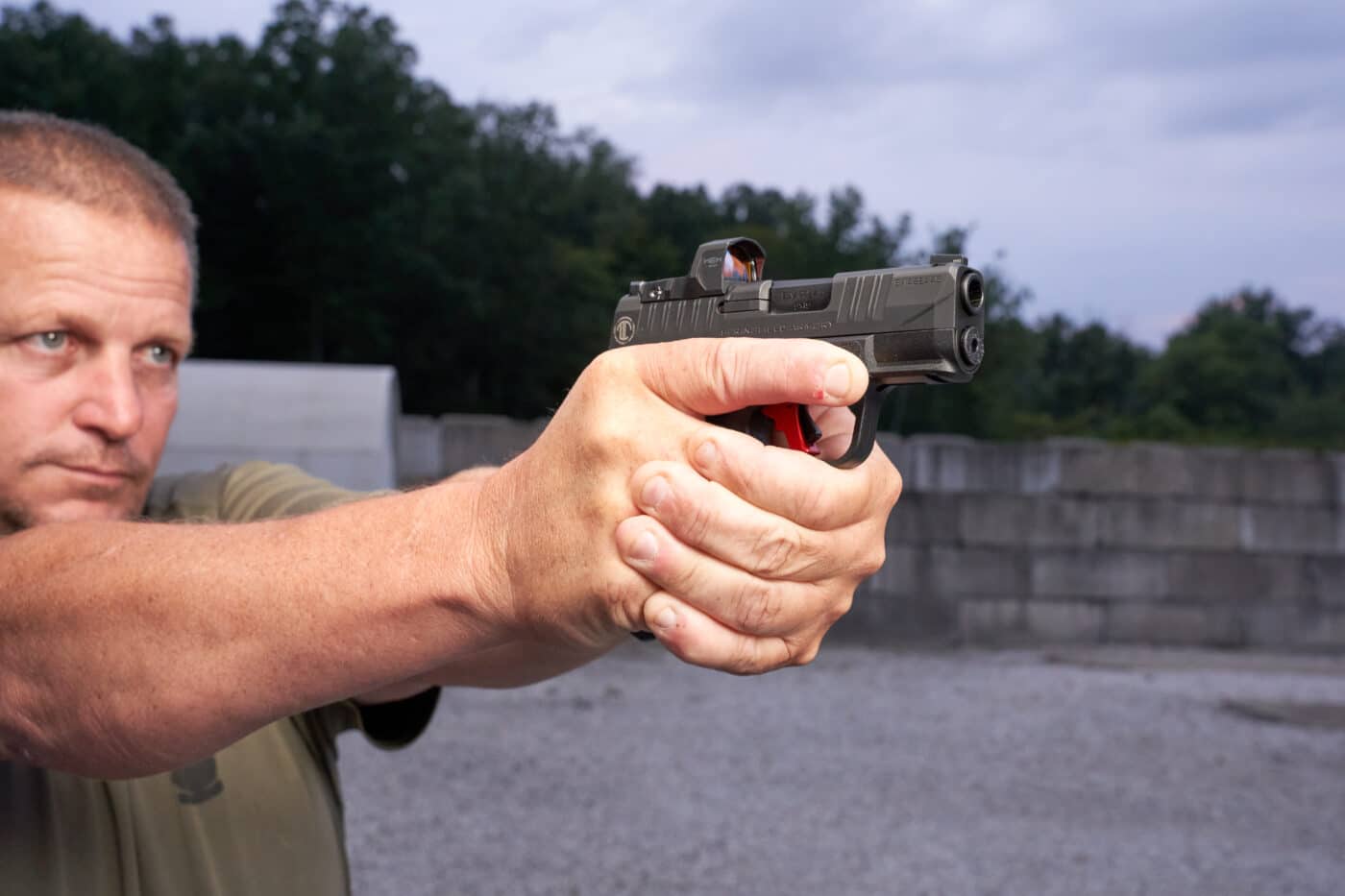 Man shooting custom Hellcat with red dot sights