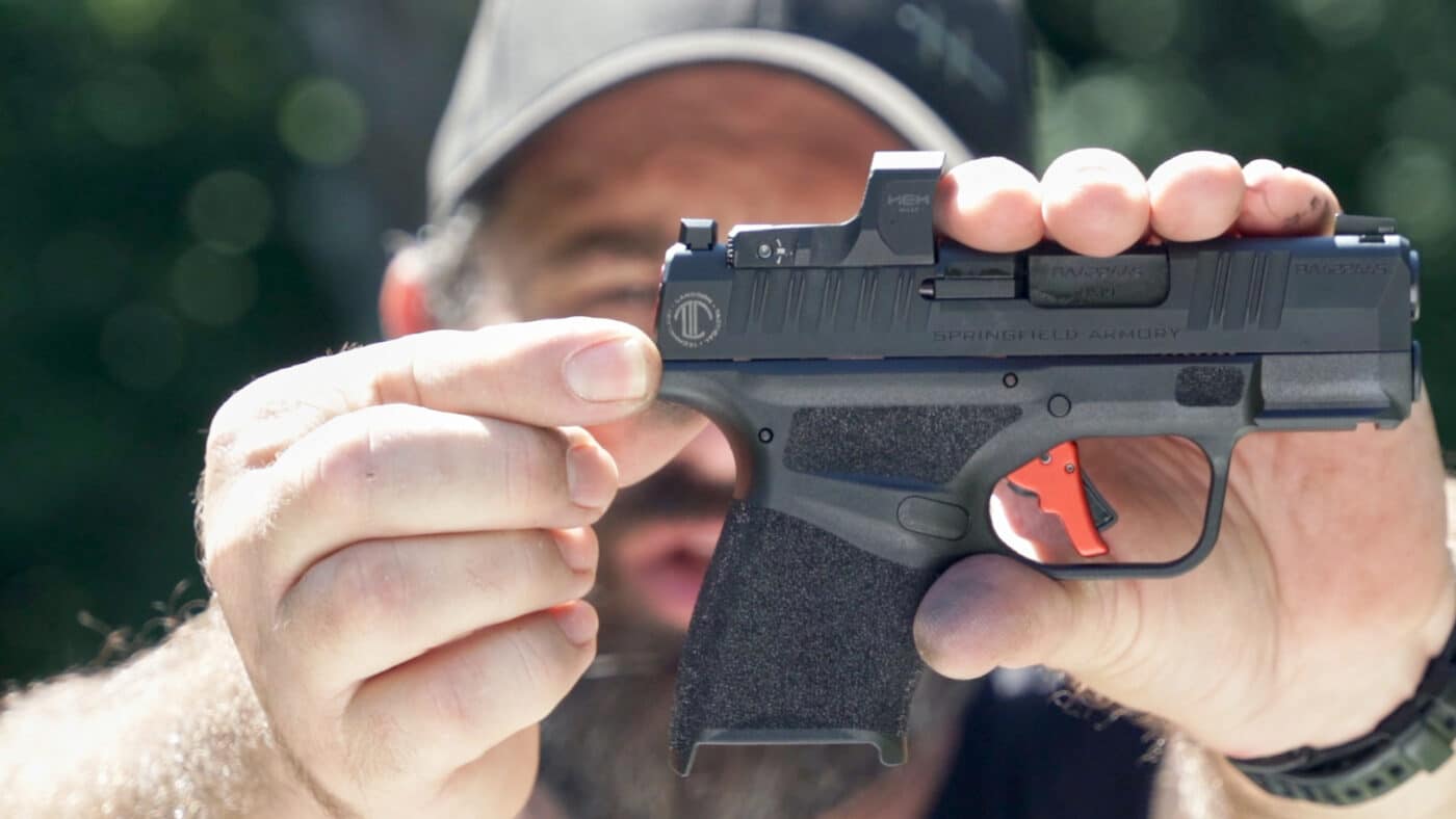 Man holding LTT Custom Hellcat pistol