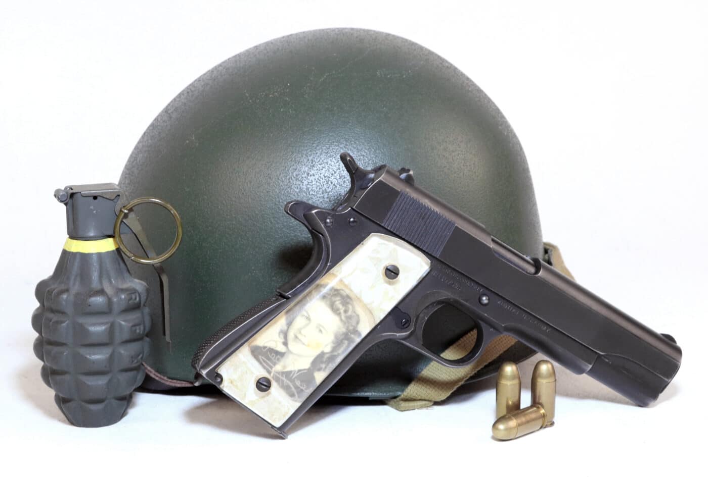 Vintage WWII sweetheart grips on 1911 with grenade, helmet, and ammo