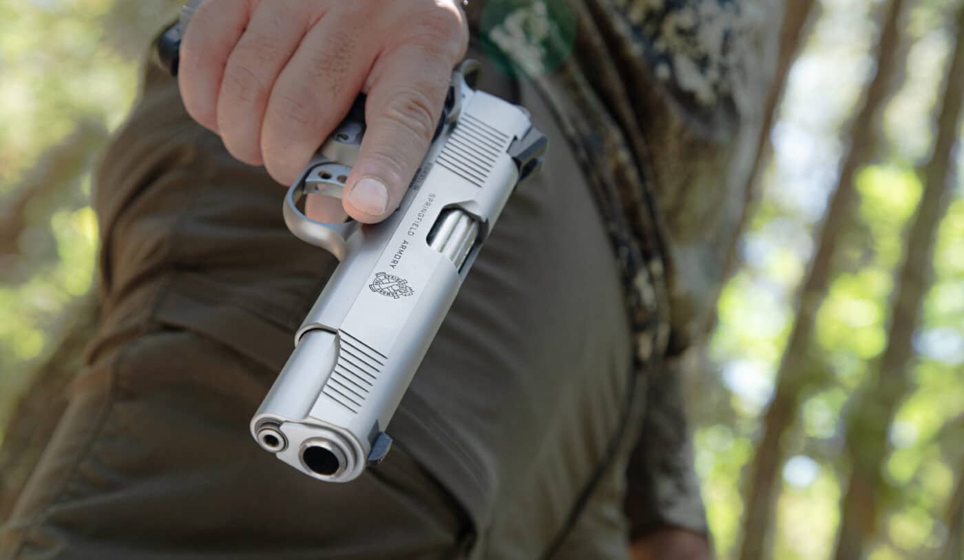 Man holding Springfield Armory stainless steel TRP 1911