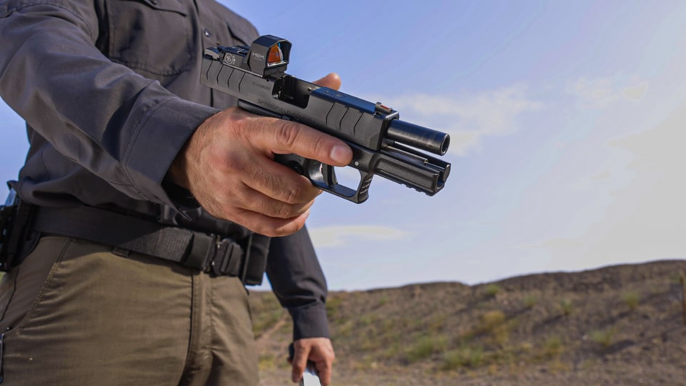 Man demonstrating a one handed grip on the XD-M Elite Compact OSP pistol