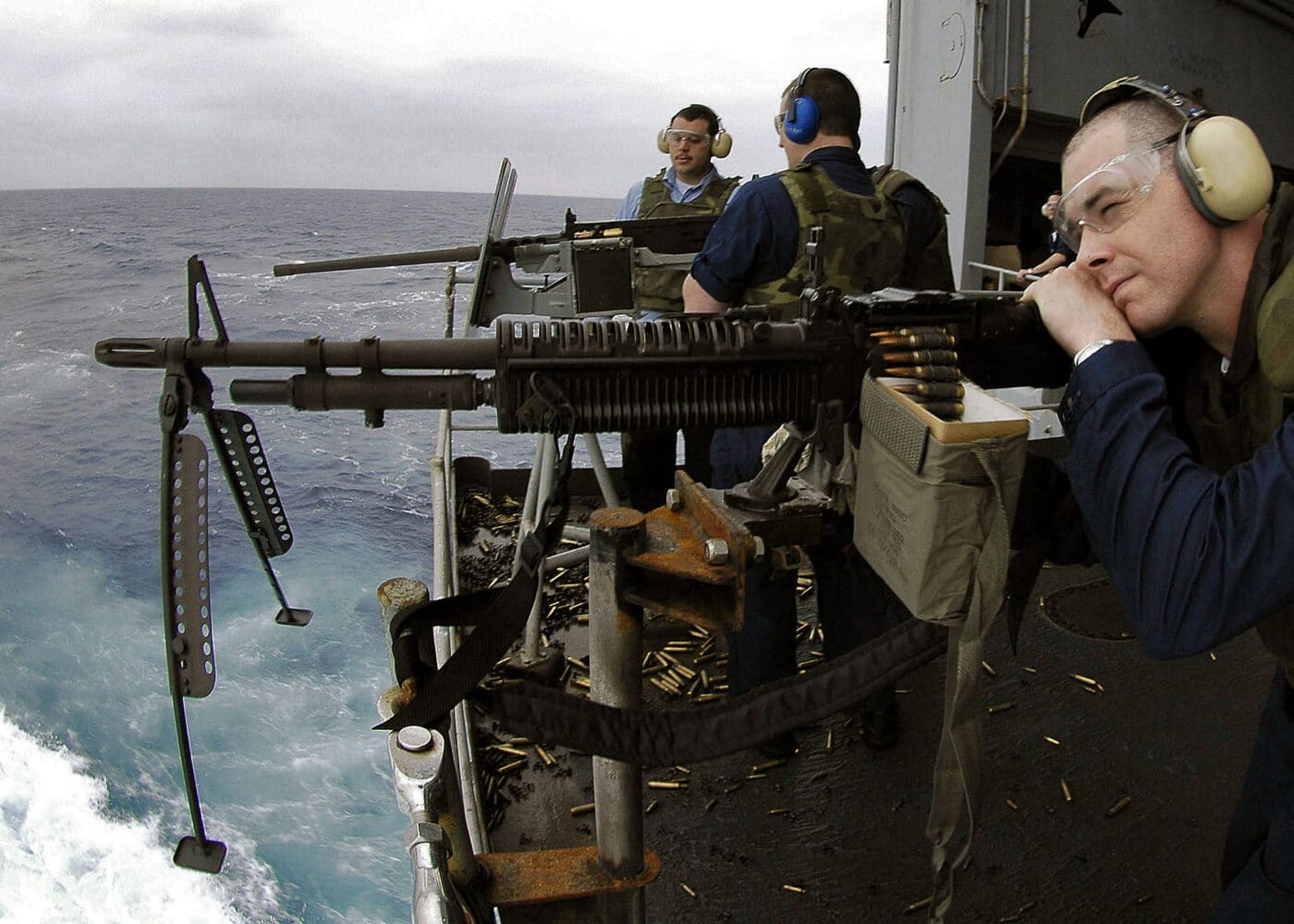 U.S. Navy sailors firing the M60 machine gun during ship exercises