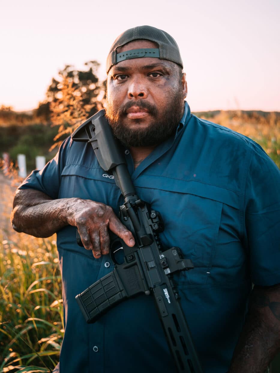 Omar “Crispy” Avila standing with rifle