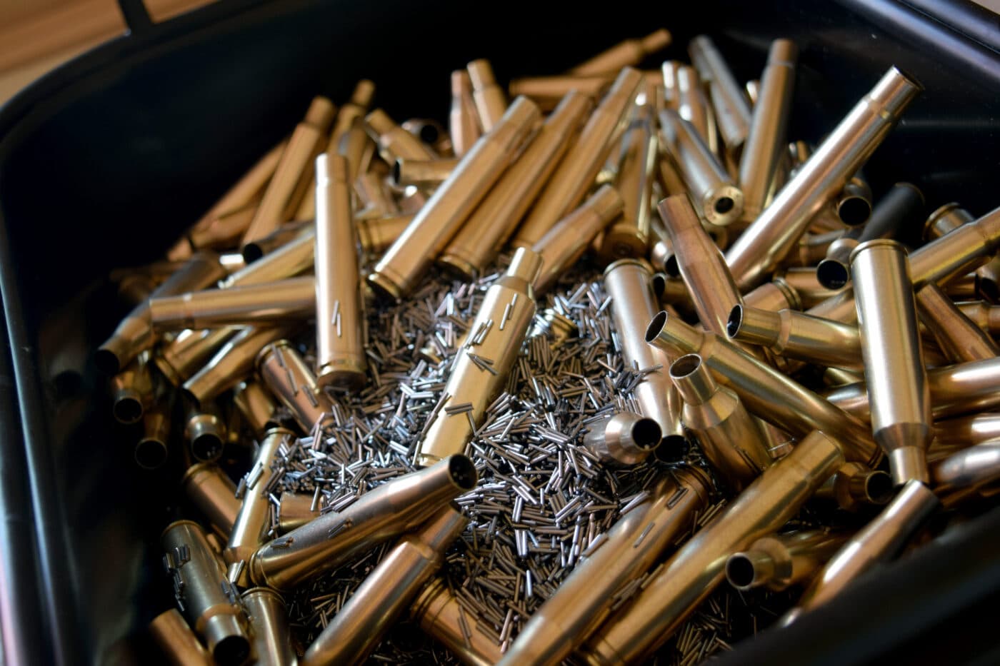 Cleaning brass cases with stainless steel media in a wet tumbler