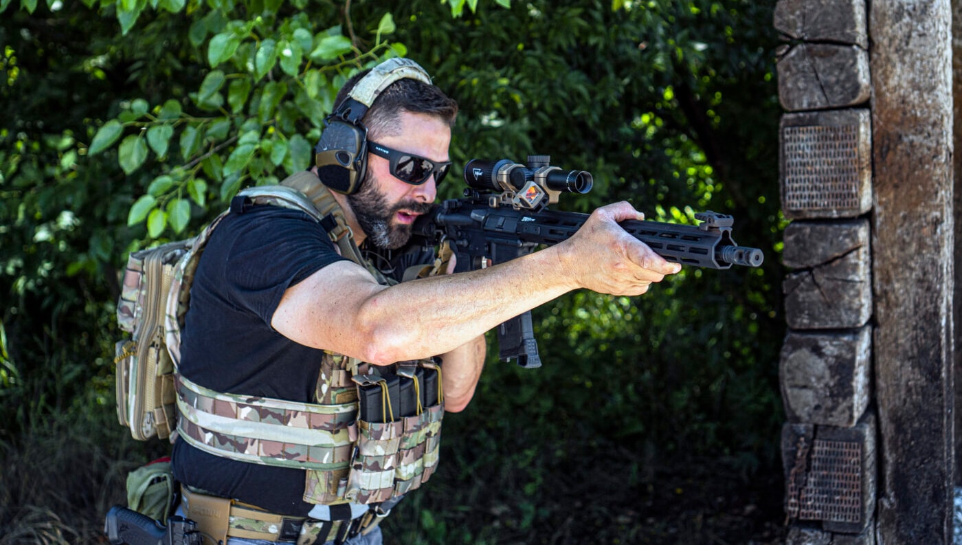 Man running an Armageddon gear AR-15 sling on a SAINT rifle