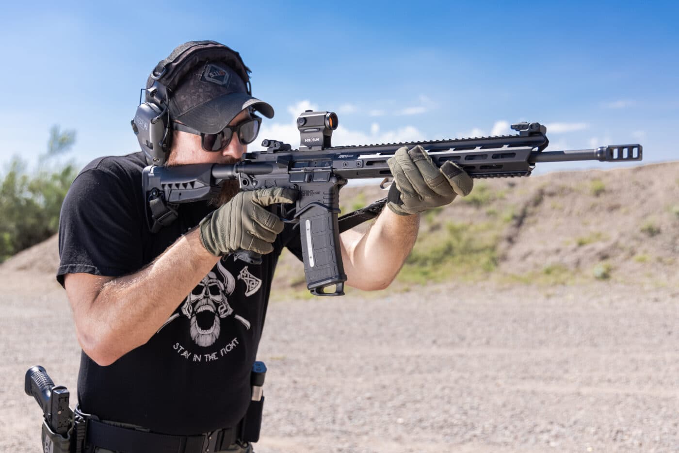 Man testing different color reticles at the range with SAINT rifle