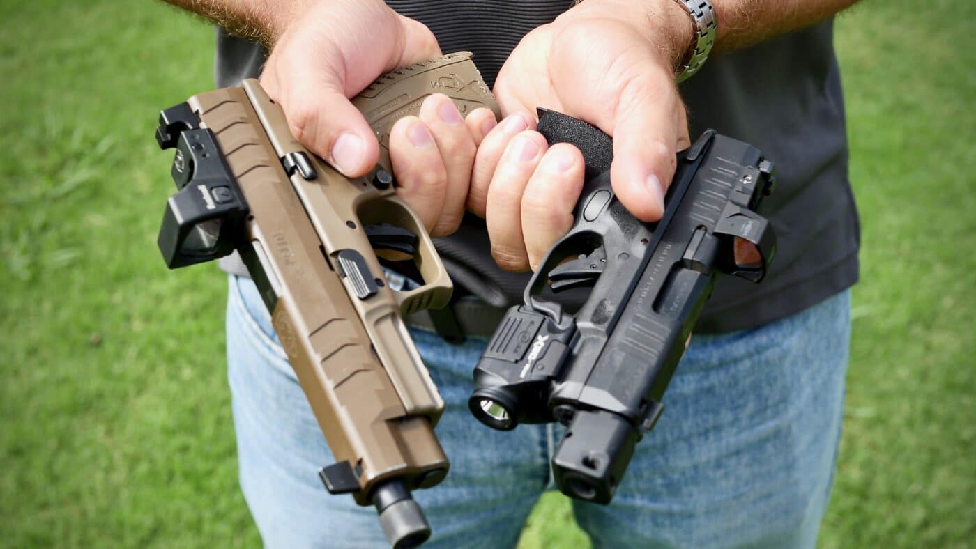 Man holding Hellcat pistol and XD-M Elite pistol to show size difference