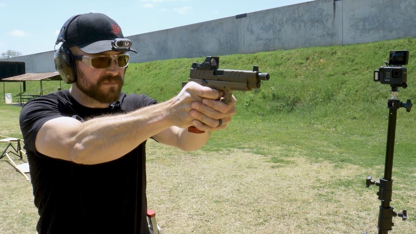 Man shooting XD-M Elite pistol at the range