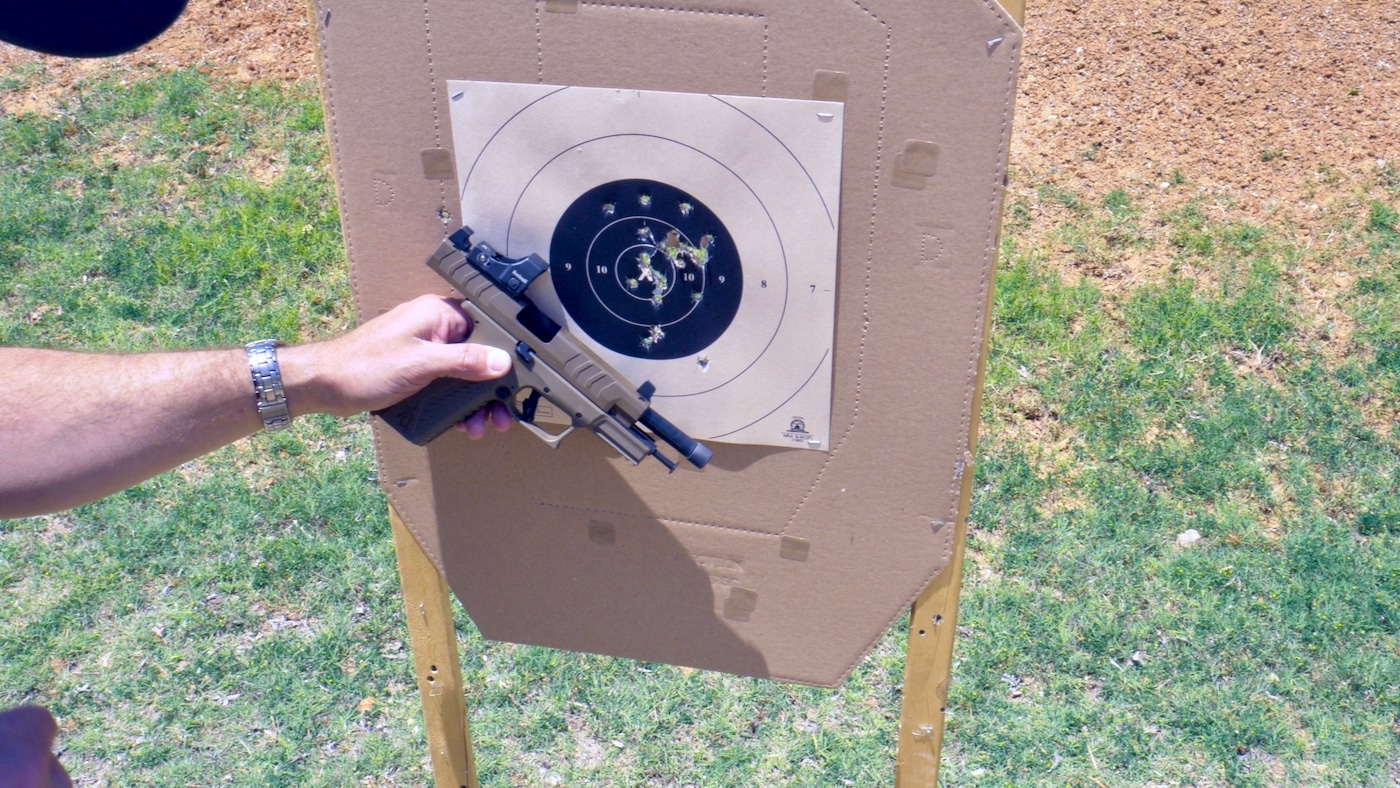 Man reviewing target results from shooting XD-M Elite pistol