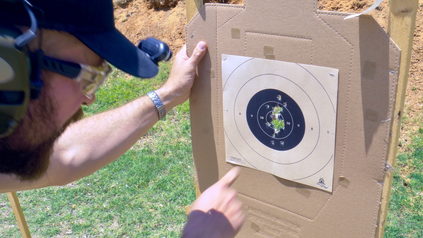 Man reviewing target results from shooting Hellcat RDP pistol