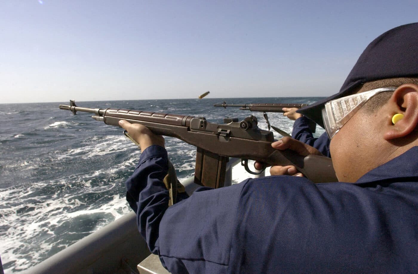 Mineman 3rd Class Arthur Cobles fires an M14 rifle during a weapons qualification aboard the USS Ardent.