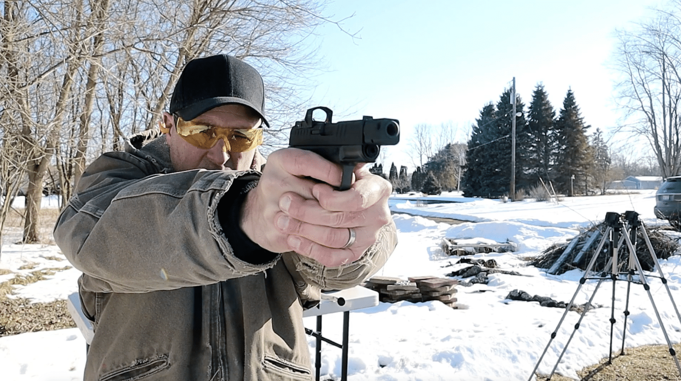 Man shooting a Hellcat RDP pistol with red dot