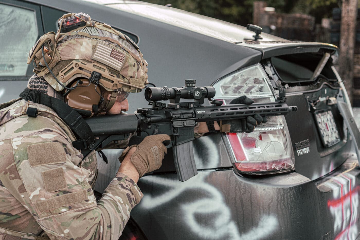 Soldier using a 1-8x scope as a red dot sight