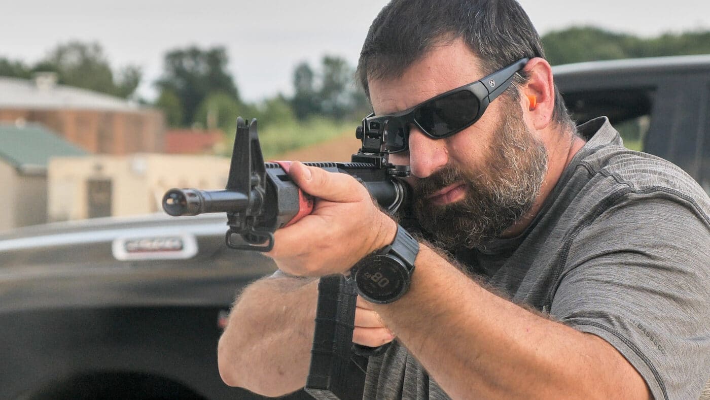 Man using standard sights on Springfield SAINT rifle