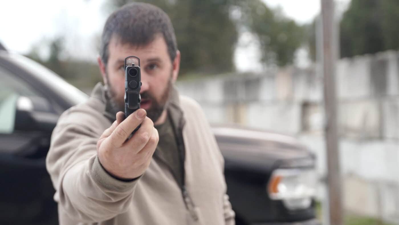 Man showing thickness of of XD-S Mod.2 OSP 3.3″ .45 ACP pistol