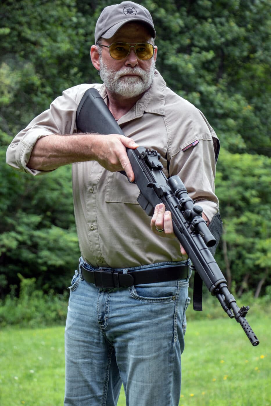 Man holding M1A rifle with scout scope