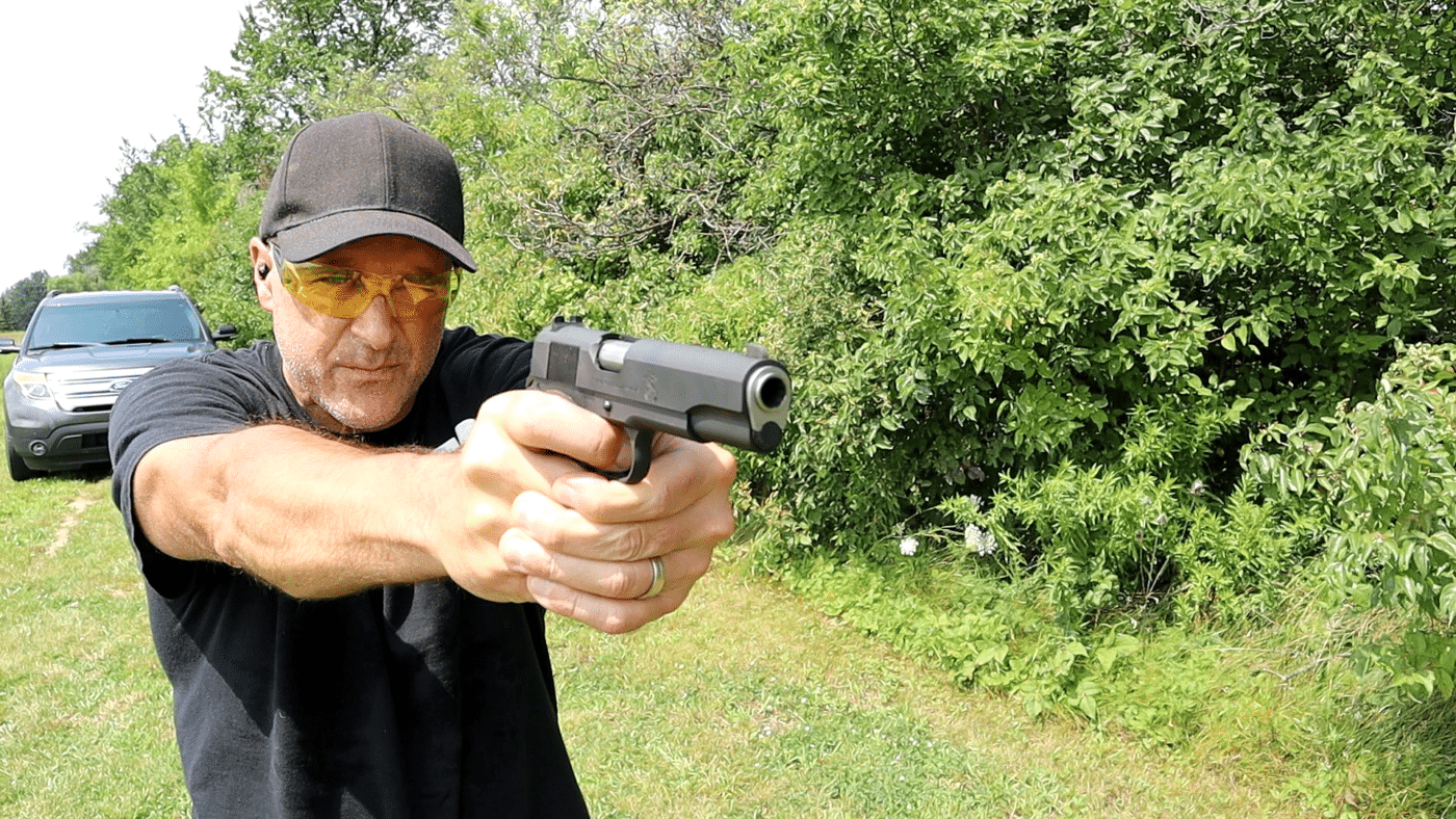 Man shooting the Springfield 1911 Mil-Spec pistol