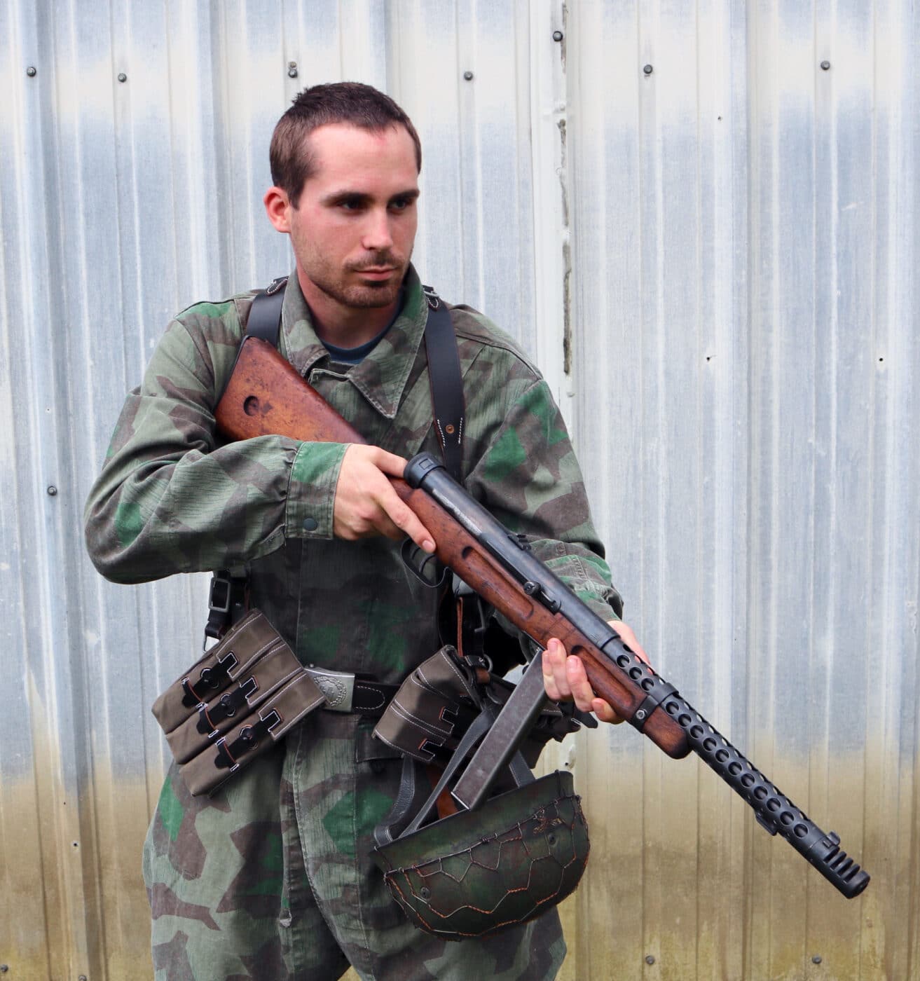 Man dressed as German SS trooper with Italian 38A SMG