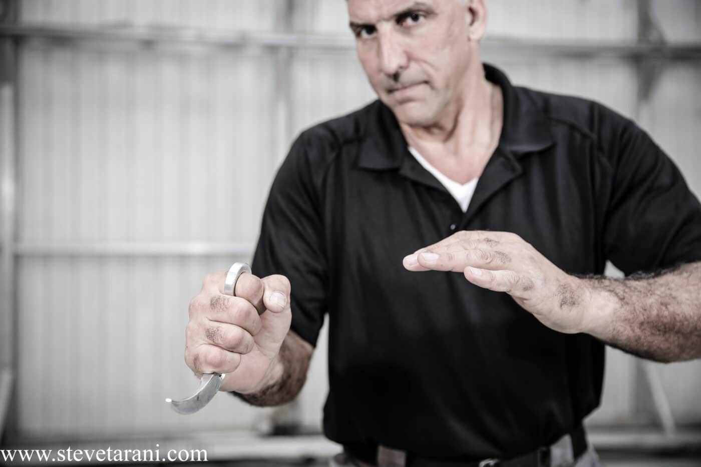 Man using a curved knife in self-defense training
