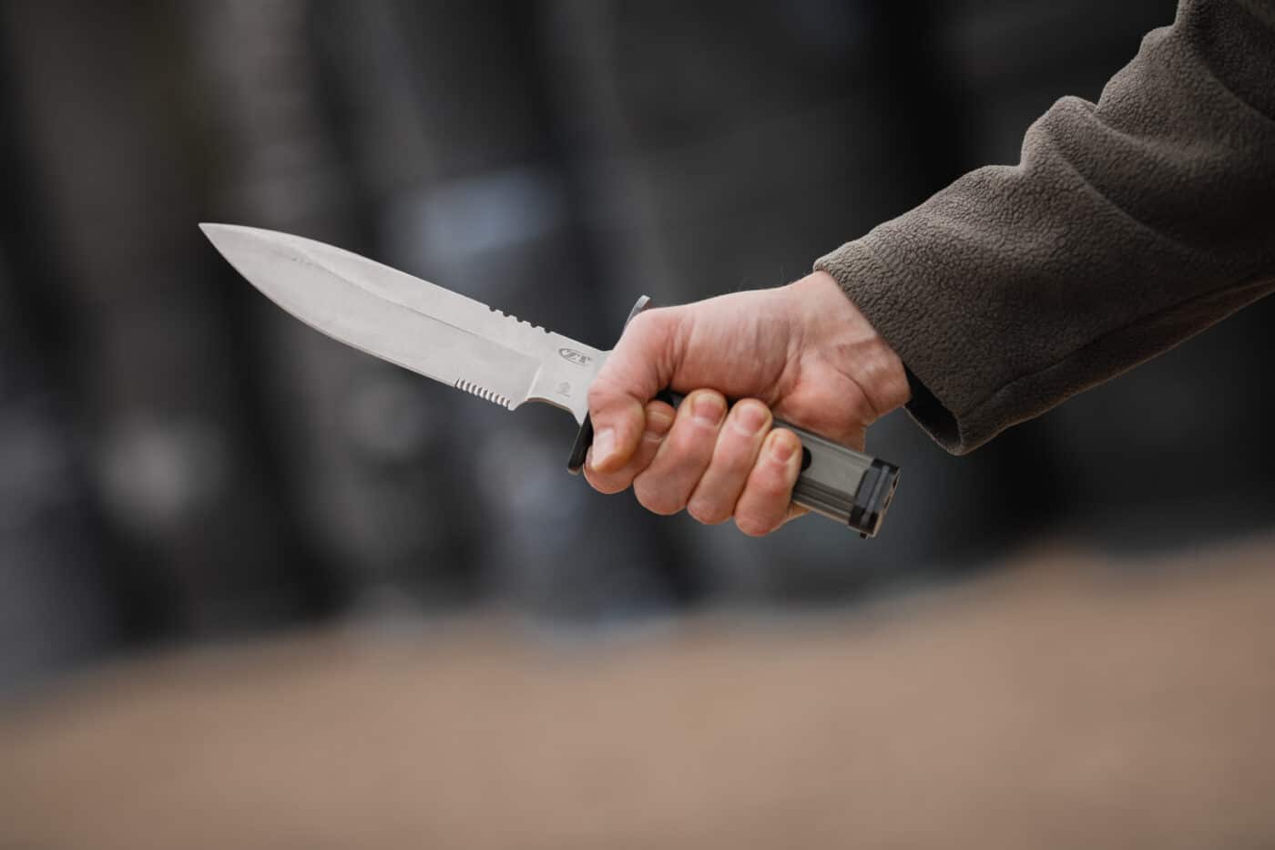 Man holding oversized fixed-blade knife