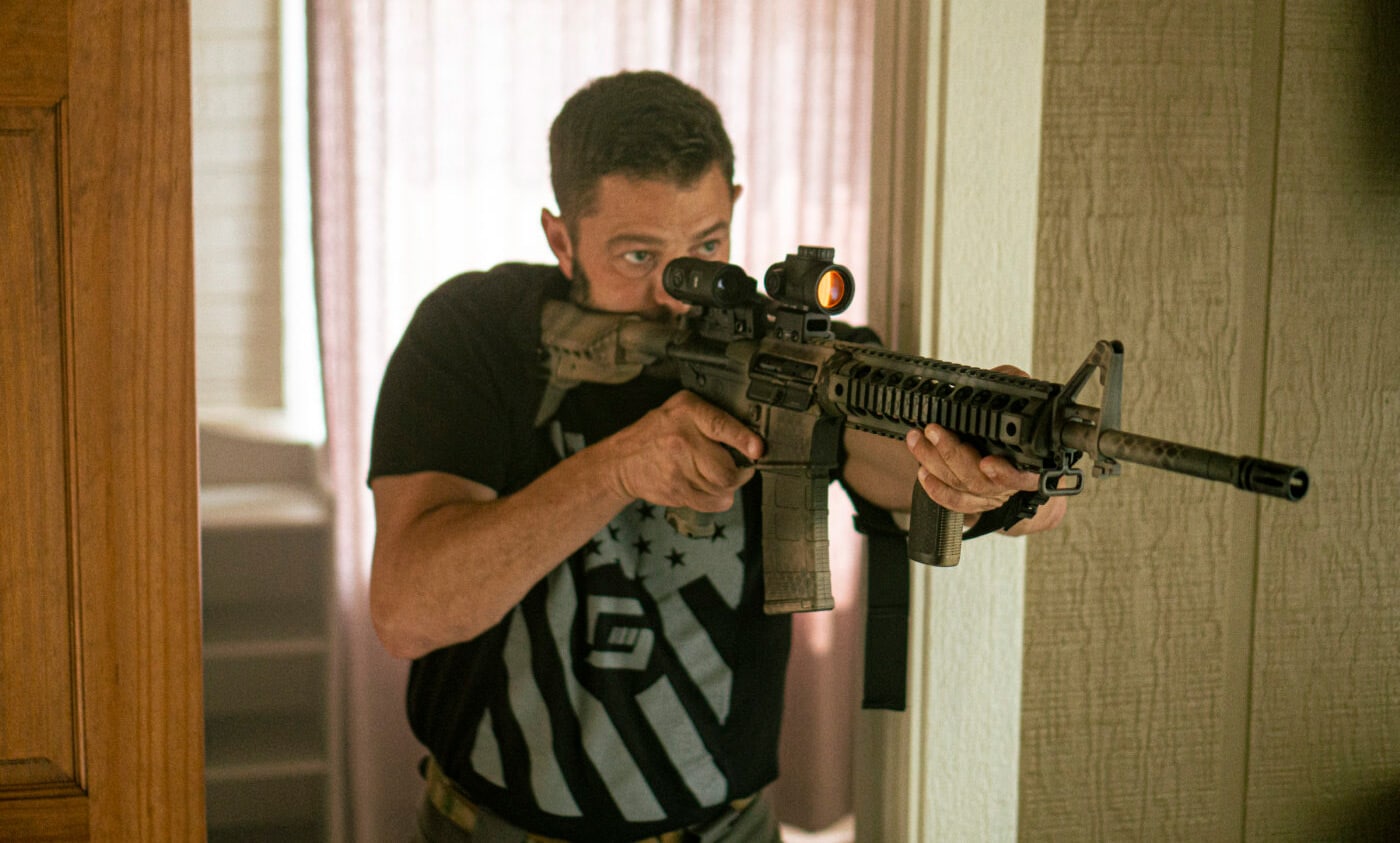 Man using a rifle during home defense