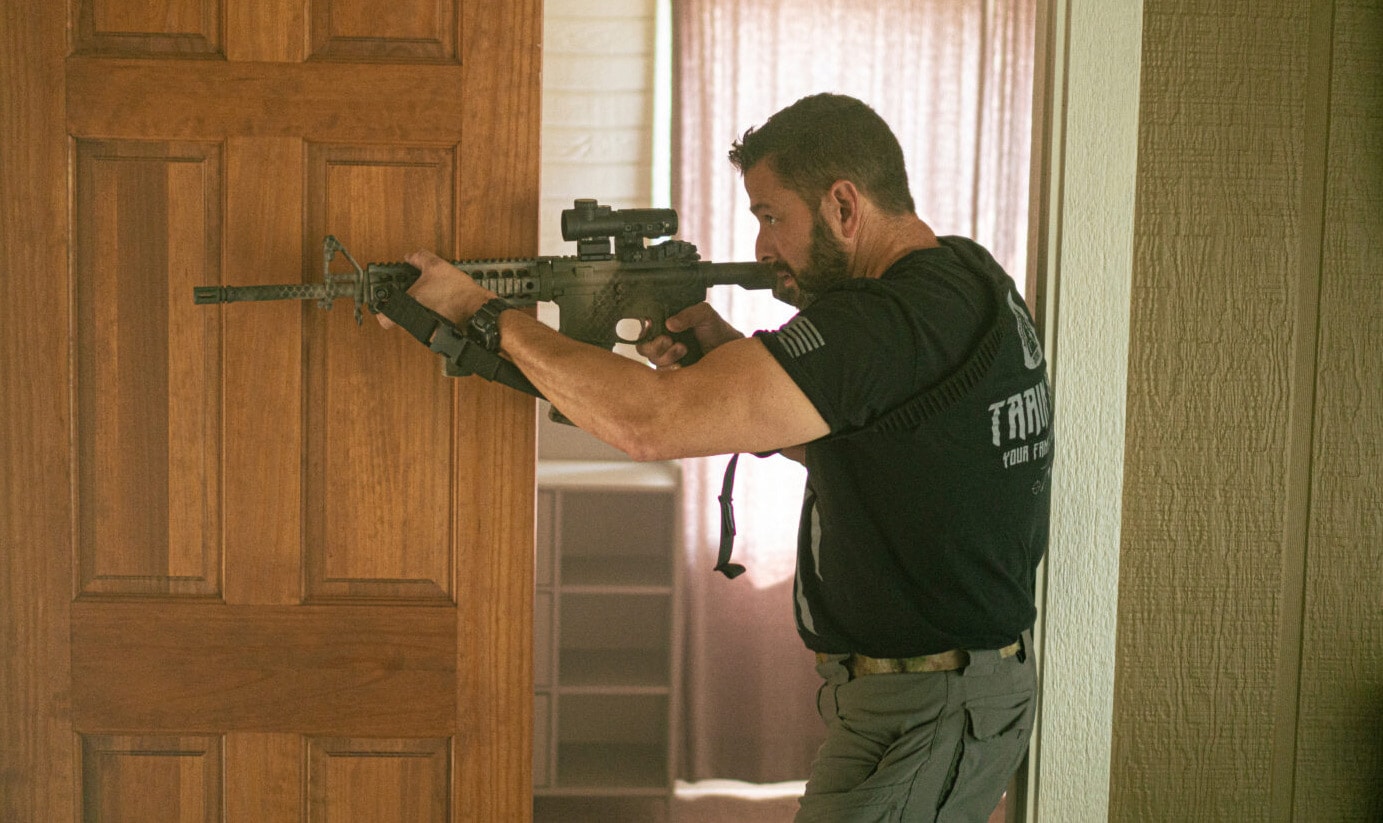 Man using a rifle in home defense situation